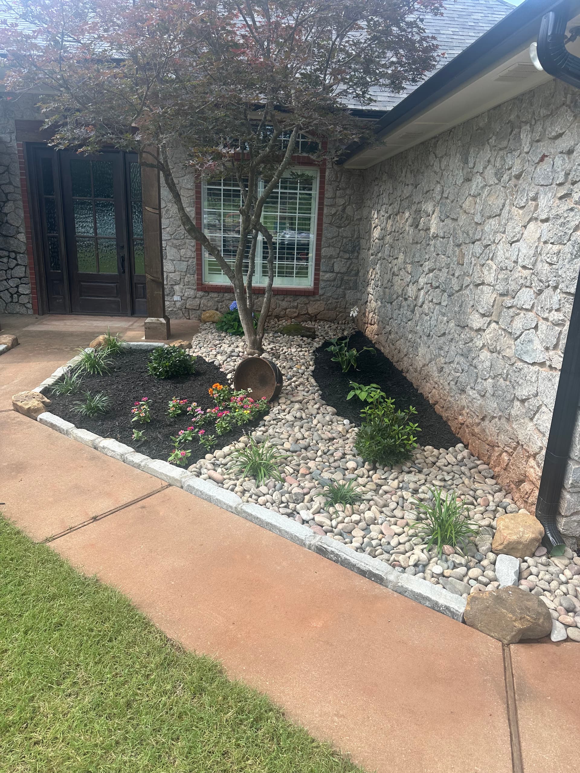 Native Perennials, Stone Work, and Fescue Sod Give This Yard a Sharp Reset image